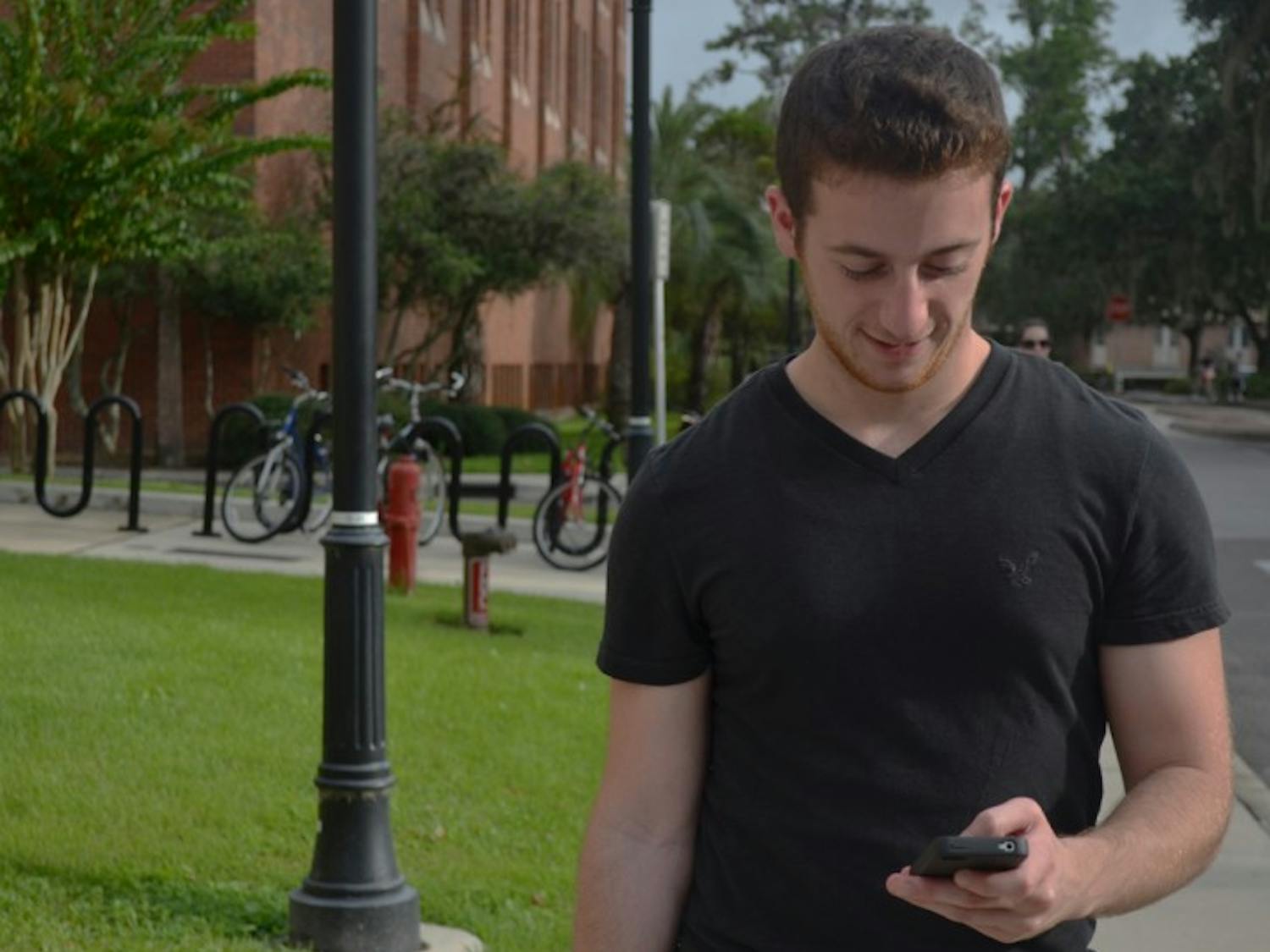 UF computer science and engineering senior Bryan Dubno, 22, the creator of UFmobile, uses the free iPhone app on campus. The app includes an interactive campus map to help students find their classes.