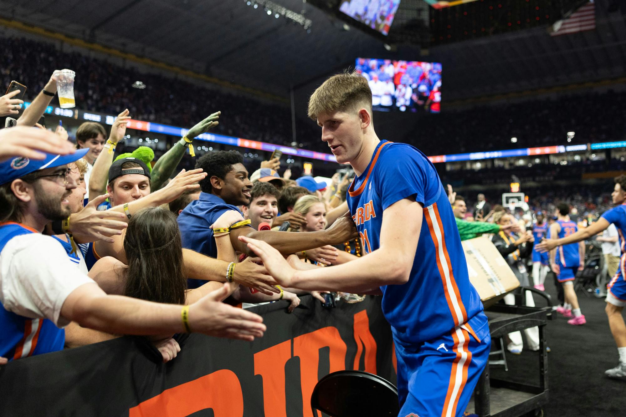 Florida Gators forward/center Alex Condon (21) celebrates with the fans after a win in a basketball game against the Auburn Tigers in the Final Four round of the NCAA Tournament on Saturday, April 5, 2025, in San Antonio, Texas.