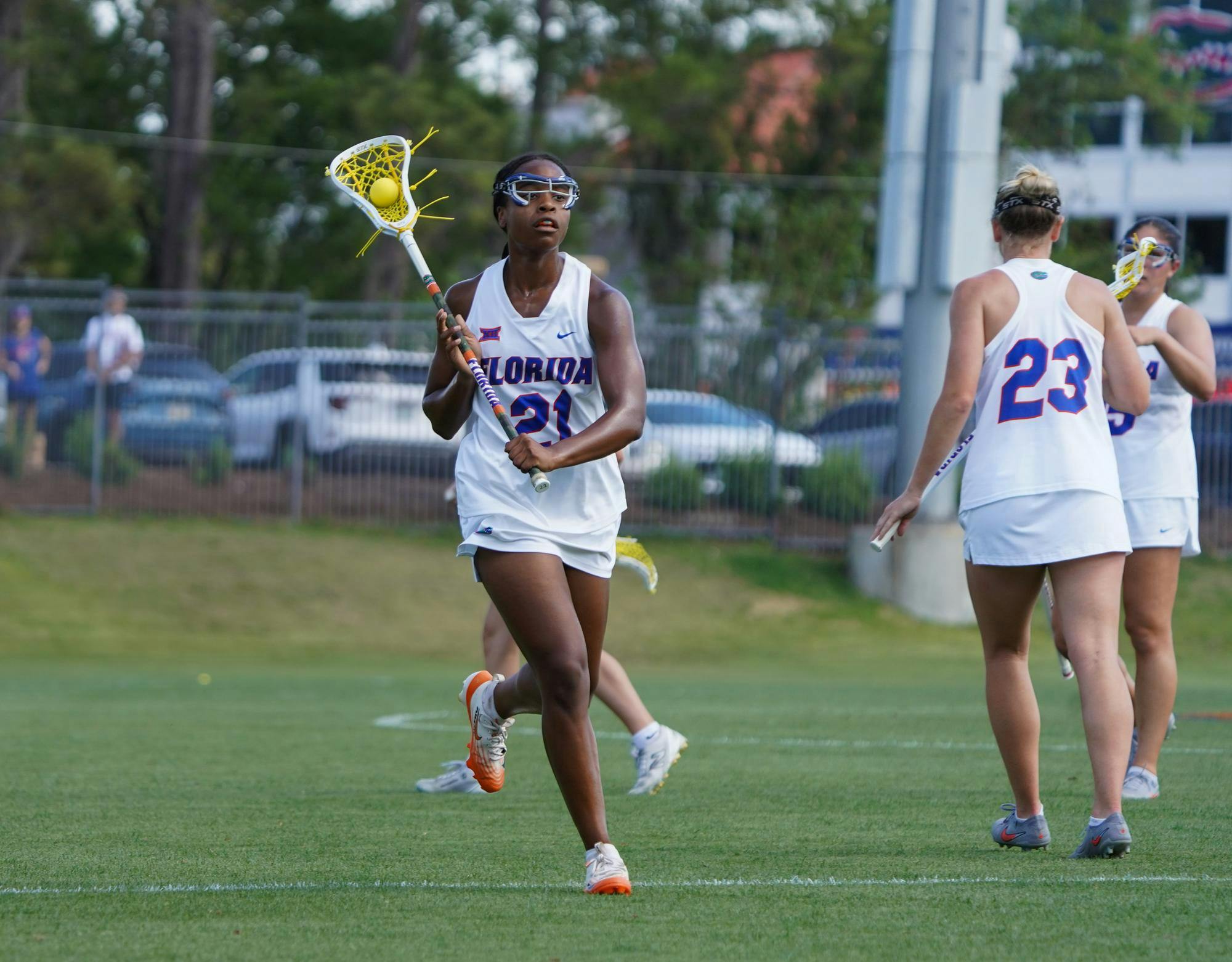 Clark Hamilton (21) cradles the ball and looks to pass during an NCAA women's lacrosse game against Colorado, Saturday, April 4, 2026, at Donald R. Dizney Stadium in Gainesville, Fla.