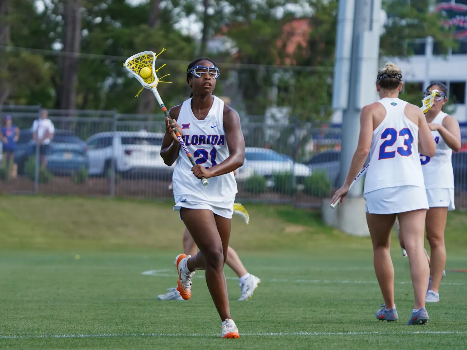 Clark Hamilton (21) cradles the ball and looks to pass during an NCAA women's lacrosse game against Colorado, Saturday, April 4, 2026, at Donald R. Dizney Stadium in Gainesville, Fla.