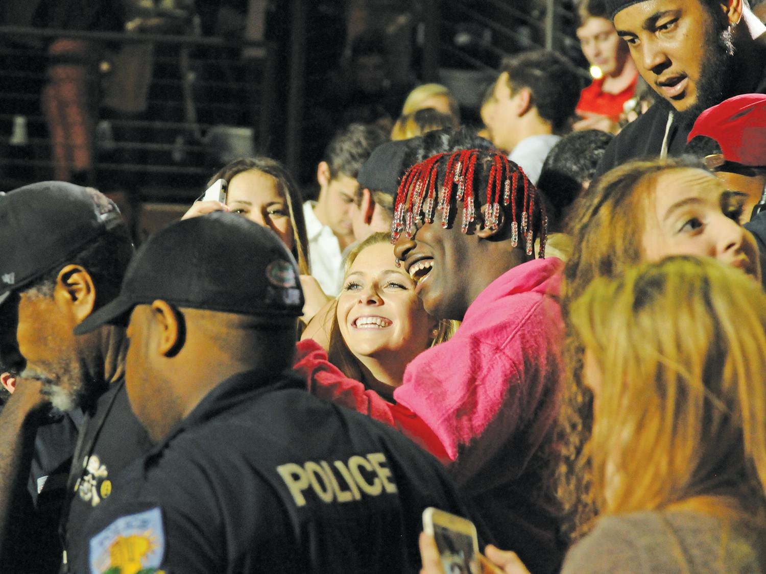 Rapper Lil Yachty takes a selfie with a girl in the crowd of about 6,000. He made an impromptu visit to the crowd during the performance on Wednesday, exciting fans before he was escorted backstage by security.