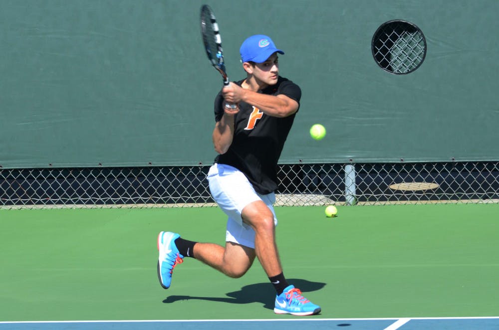 <p>Elliott Orkin returns a ball during Florida's 9-3 win against William &amp; Mary on Saturday at the Ring Tennis Complex.</p>