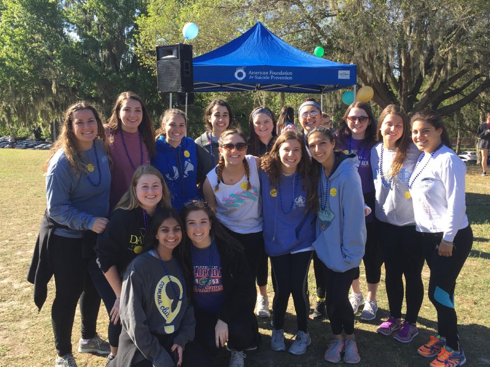 Participants in the second-annual Out of the Darkness 3k pose for a photo. The walk was held to raise awareness for suicide prevention, and participants raised more than $10,000 on Saturday morning.  