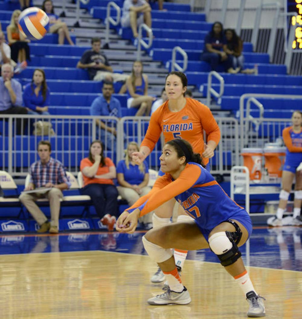 <p align="justify">Sophomore outside hitter Noami Santos-Lamb (17) squats to bump the ball during Florida’s 3-0 victory against New Orleans on Friday in the O’Connell Center. Florida won all three of its weekend matches.</p>