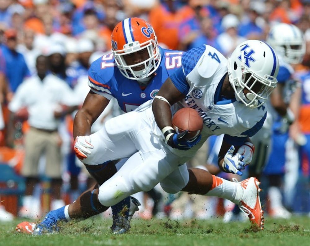 <p>Florida linebacker Michael Taylor (51) tackles Kentucky tailback Raymond Sanders III (4) on Saturday in Ben Hill Griffin Stadium. Taylor has received more playing time since linebacker Jelani Jenkins suffered a broken thumb on Sept. 8 against the Texas A&amp;M Aggies.</p>