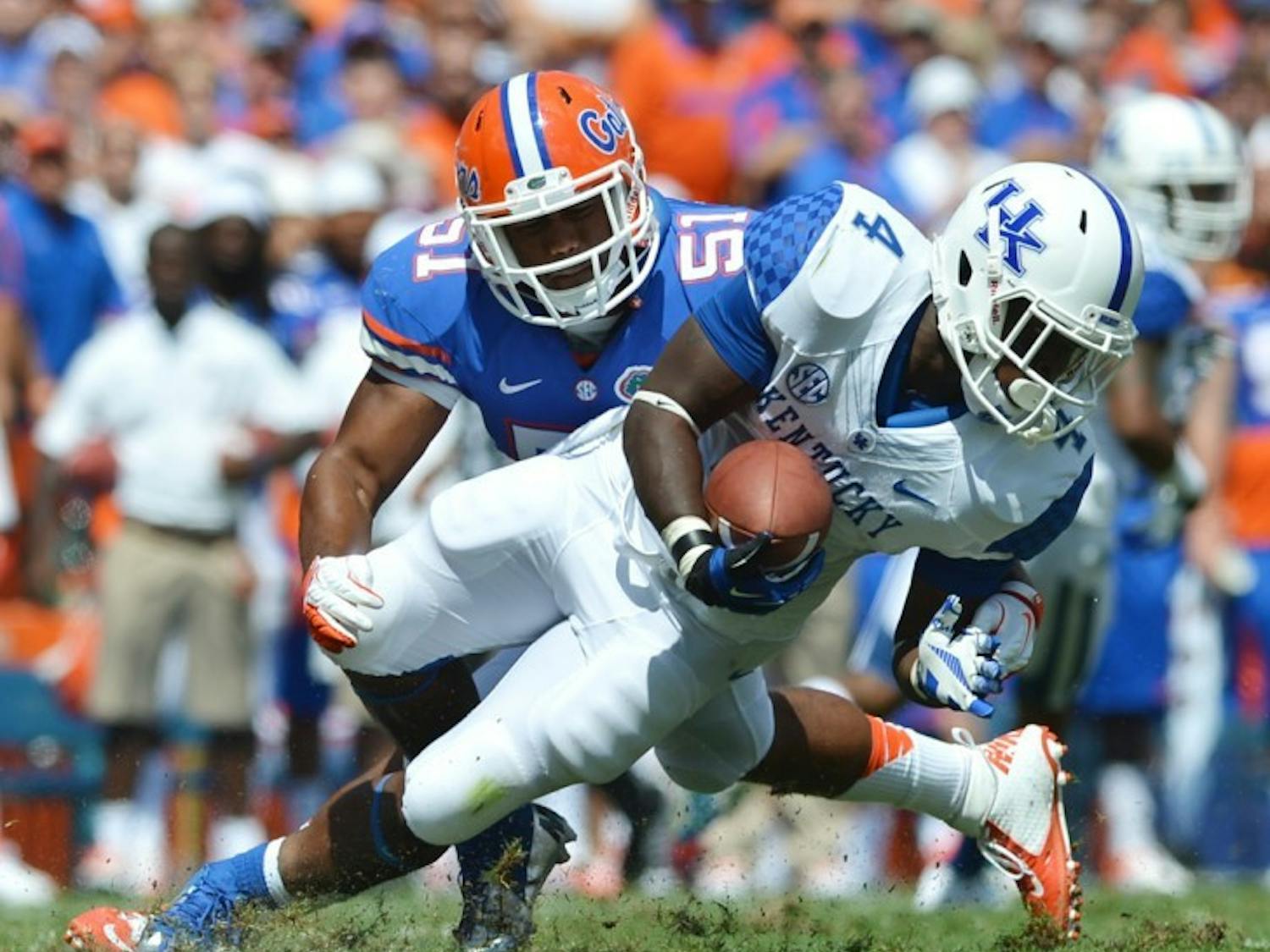 Florida linebacker Michael Taylor (51) tackles Kentucky tailback Raymond Sanders III (4) on Saturday in Ben Hill Griffin Stadium. Taylor has received more playing time since linebacker Jelani Jenkins suffered a broken thumb on Sept. 8 against the Texas A&amp;M Aggies.