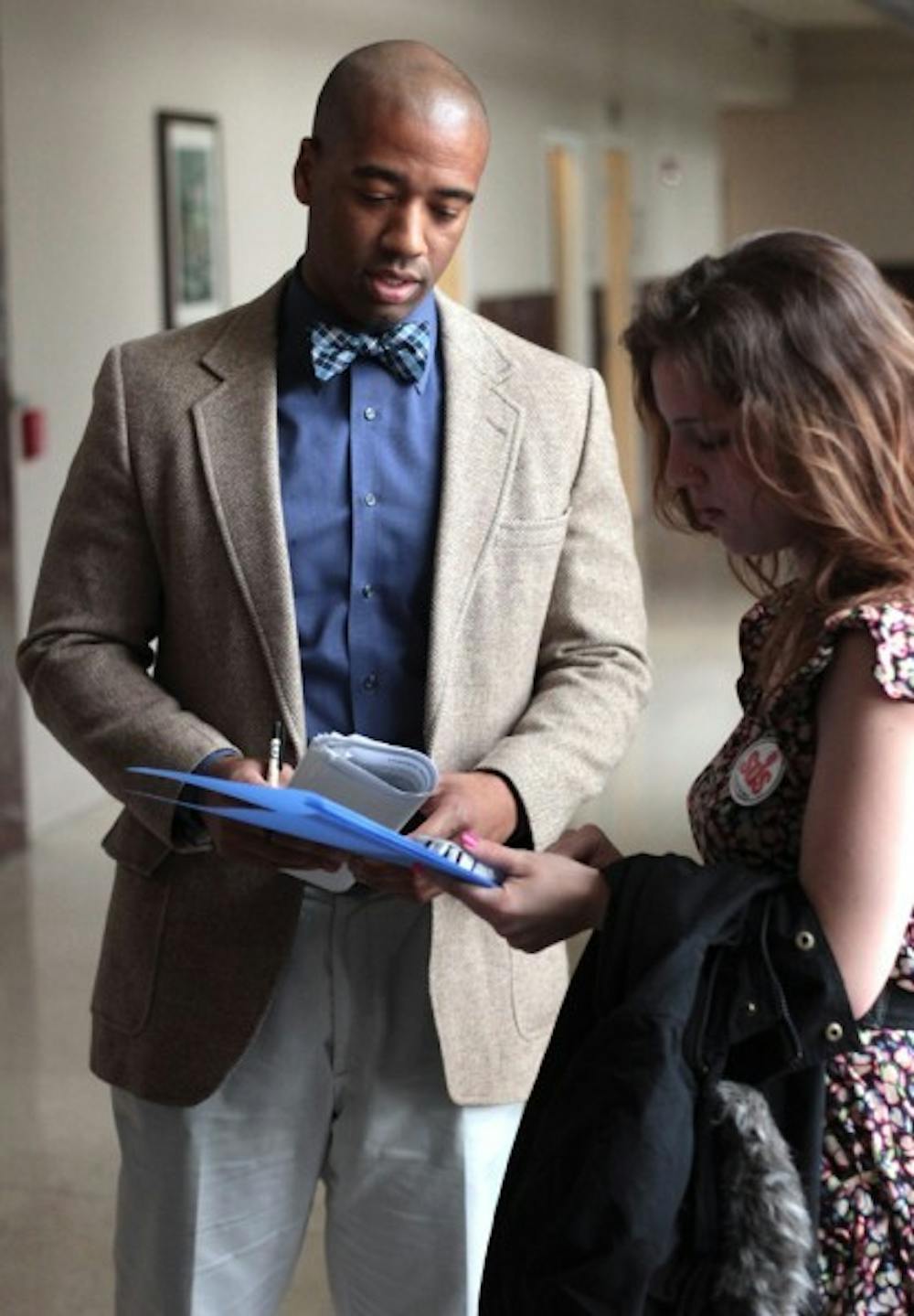 <p>Students for Democratic Society representative Skye Schmelzer, 19, speaks with Jamal Sowell, executive assistant to President Machen about fair wages for RTS bus drivers. Schmelzer's key point was for drivers to no longer have forced overtime.</p>