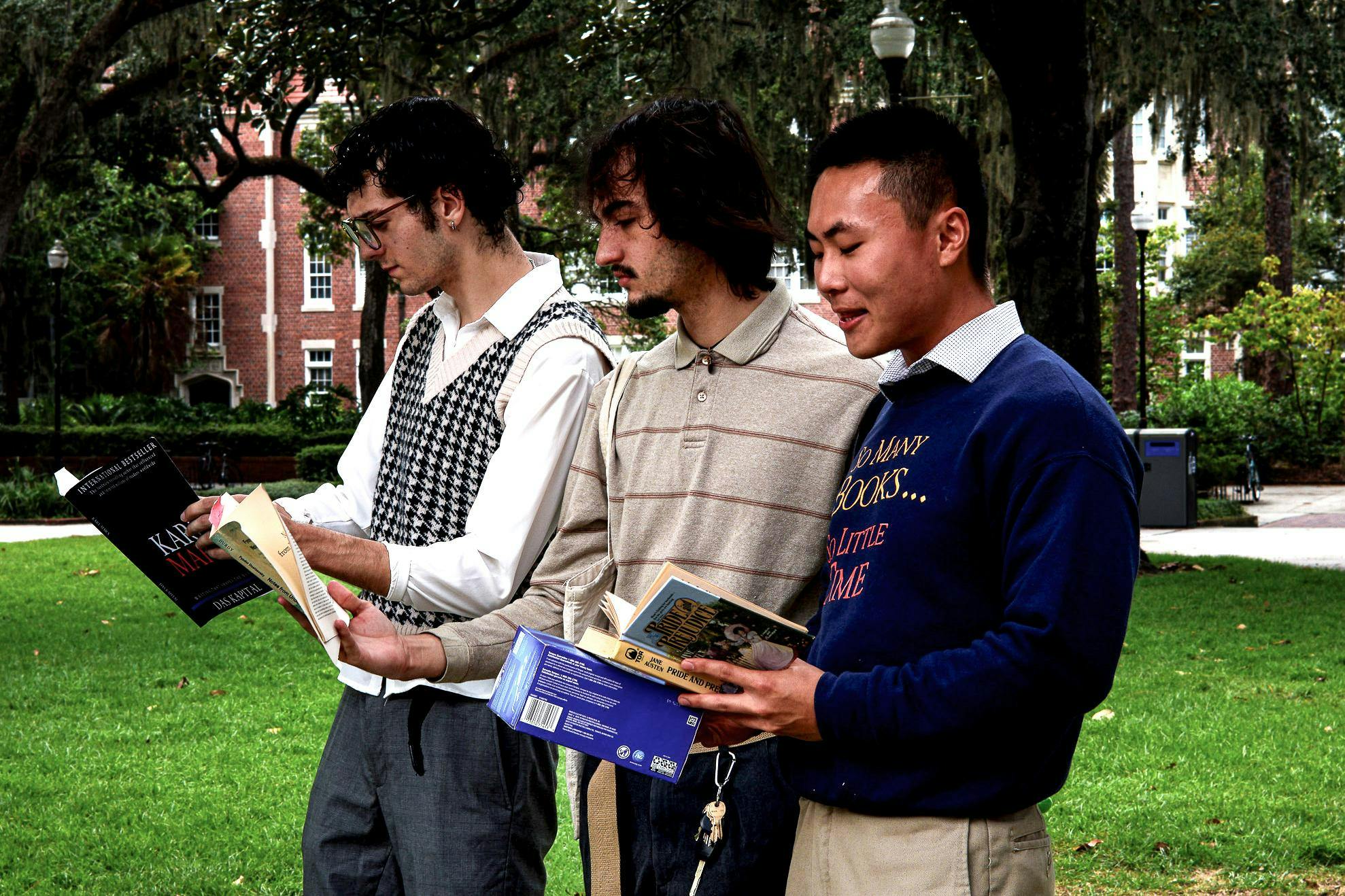 Three performative males reading books at Plaza of the Americas on Monday, Sept. 1, 2025.