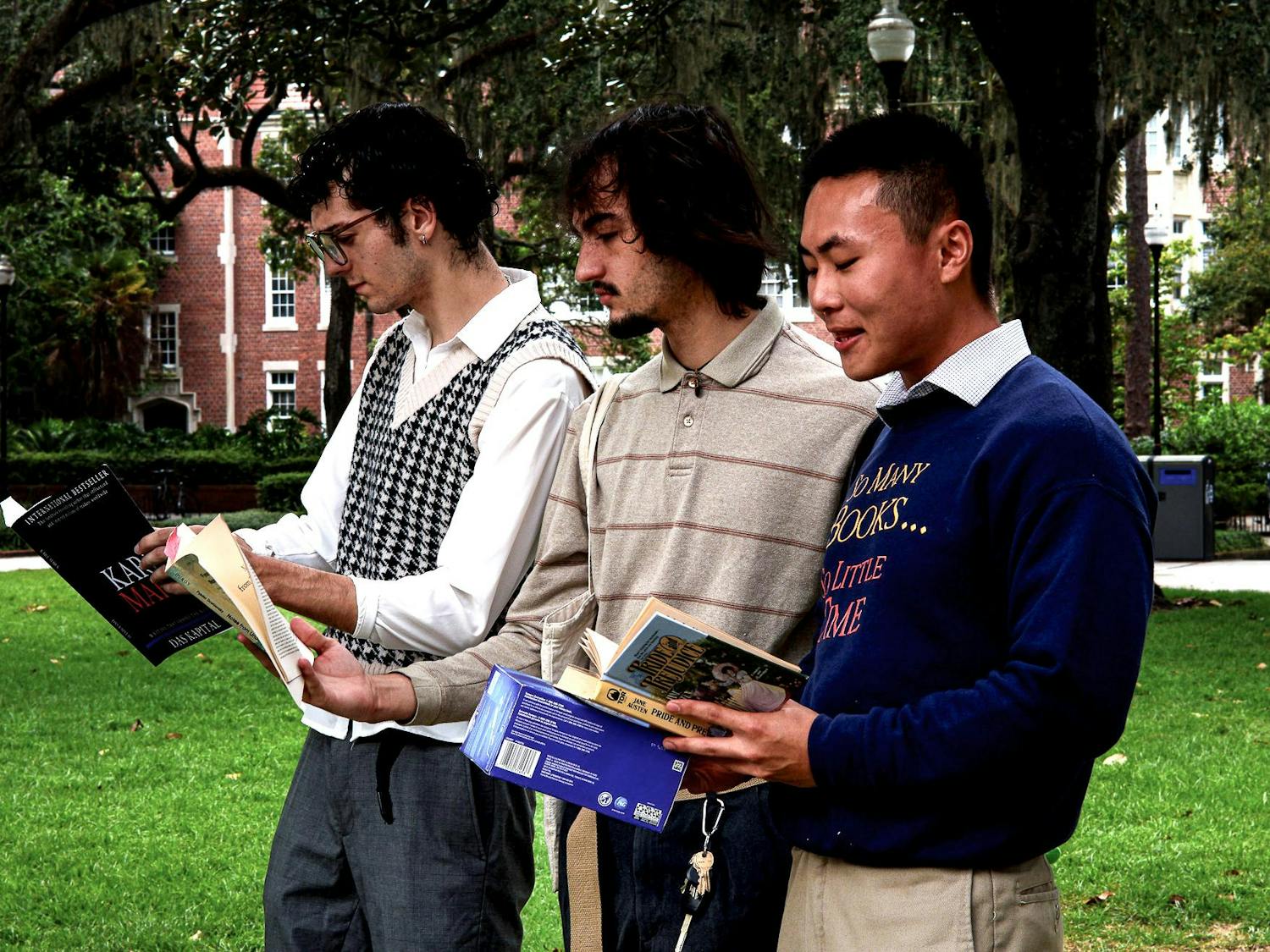 Three performative males reading books at Plaza of the Americas on Monday, Sept. 1, 2025.