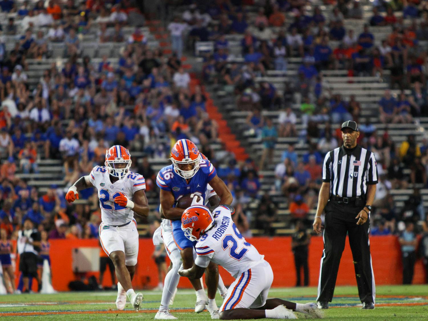 Florida linebacker Jaden Robinson tackles UF wide receiver Thai Chiaokhiao-Bowman in the Gators' Orange and Blue Game Thursday, April 13, 2023.