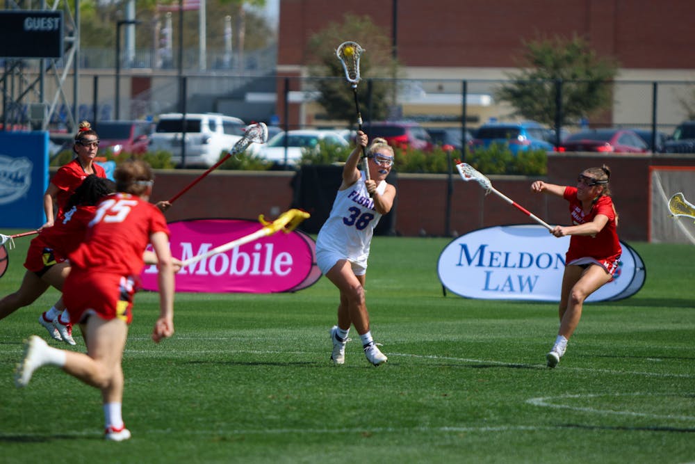 Florida attacker Tayler Warehime holds the ball in her crosse in the Gators' 14-13 loss to the Maryland Terrapins Saturday, Feb. 25, 2023.
