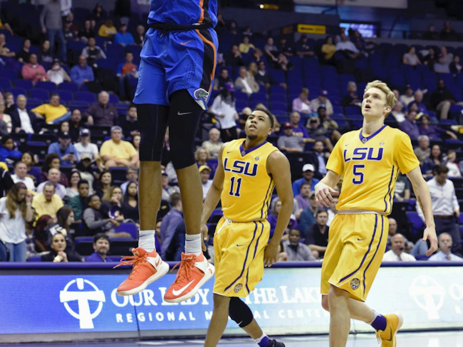 Florida forward Devin Robinson (1) dunks the ball for two of his game high 24-points as LSU guard Jalyn Patterson (11) and LSU guard Kieran Hayward (5) watch in the second half of an NCAA college basketball game, Wednesday, Jan. 25, 2017, in Baton Rouge, La. Florida won 106-71. (AP Photo/Bill Feig)
