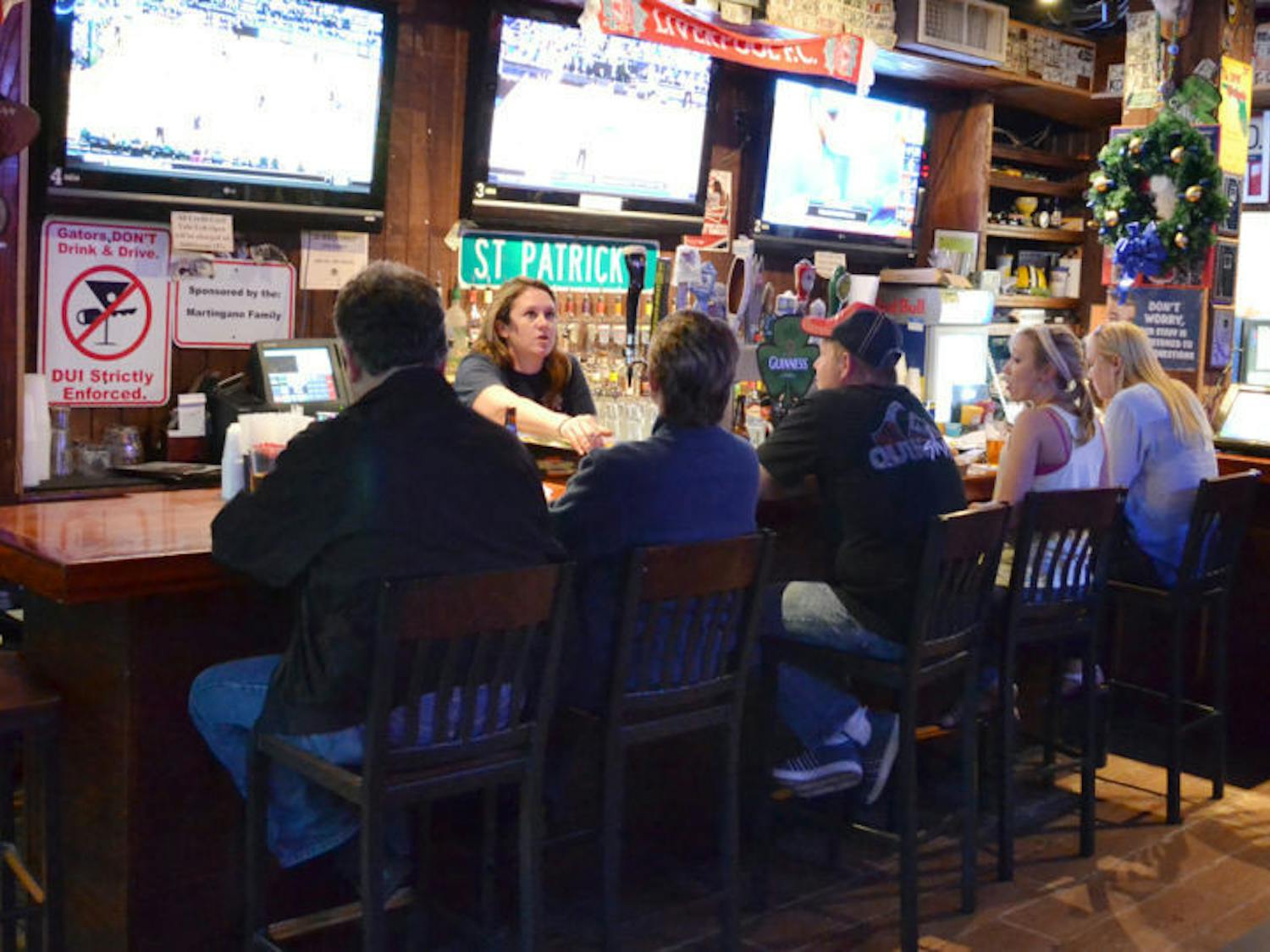 Patrons gather at Mother’s Pub and Grill on Tuesday evening. A recent UF study found that alcohol tolerance gets worse with age.