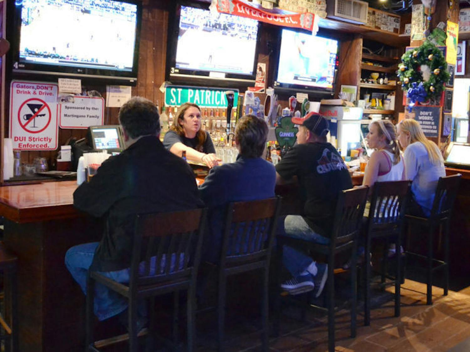 Patrons gather at Mother’s Pub and Grill on Tuesday evening. A recent UF study found that alcohol tolerance gets worse with age.