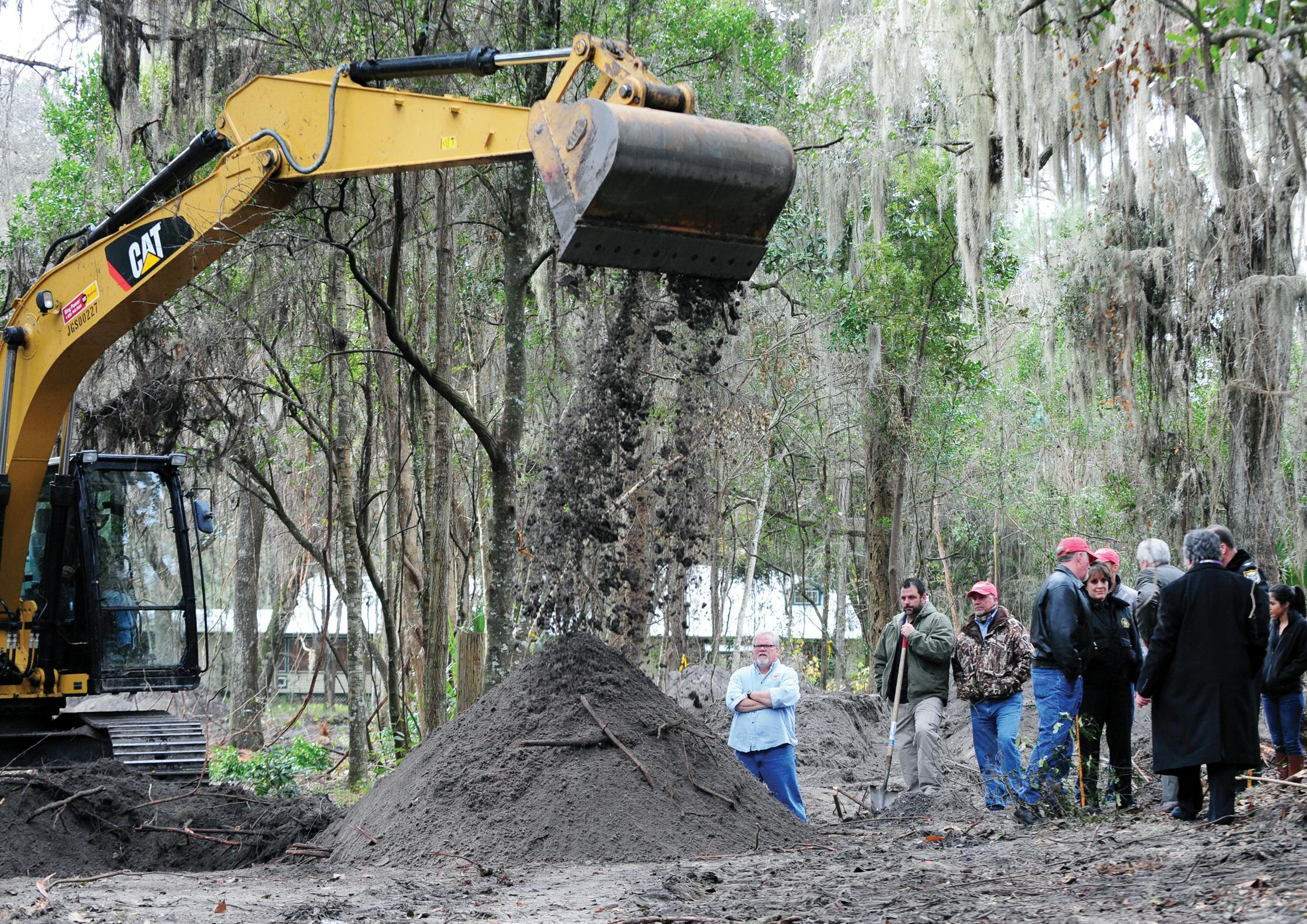 Family, friends and investigators surround a dig site potentially containing the remains of Tiffany Sessions before a press conference Thursday. Authorities announced developments in the investigation.