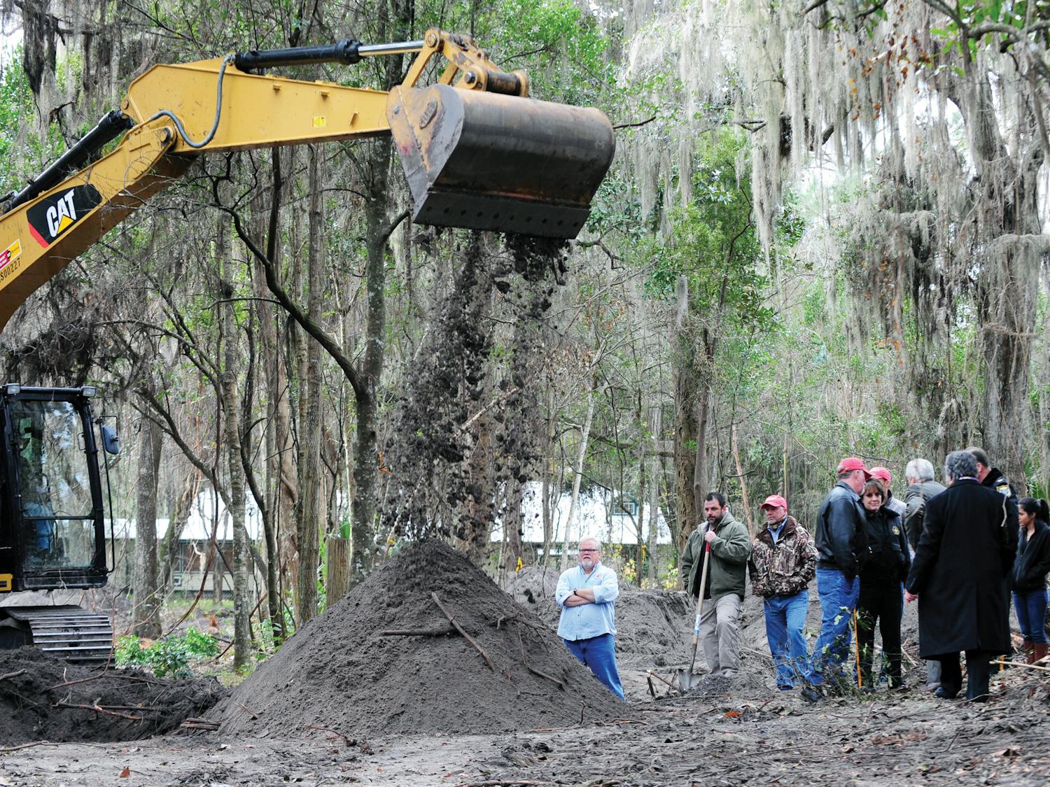 Family, friends and investigators surround a dig site potentially containing the remains of Tiffany Sessions before a press conference Thursday. Authorities announced developments in the investigation.
