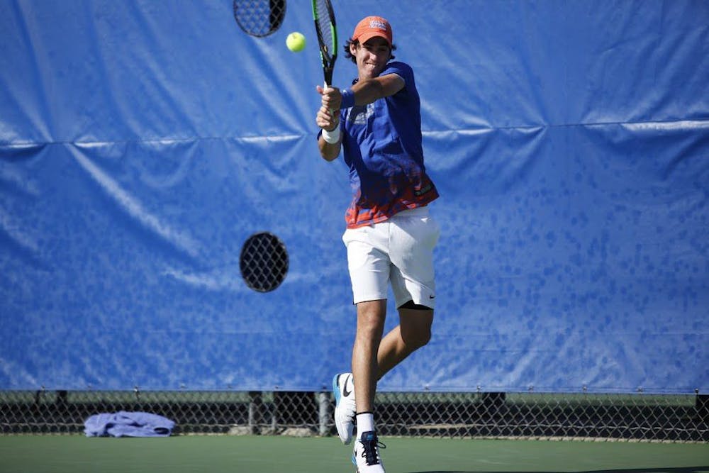 <p>Alfredo Perez hits a backhand during Florida's 4-2 against UCLA on Feb. 5, 2017, at the Ring Tennis Complex.</p>