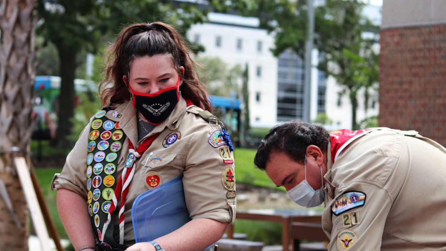 Olivia Foli, 16, an eagle scout who helped start Gainesville’s first female troop, and her dad, Randy Foli, take some of the 676 painted healing stones out of its containers at the UF Health Children's Healing Garden on Friday, Sept. 18, 2020.