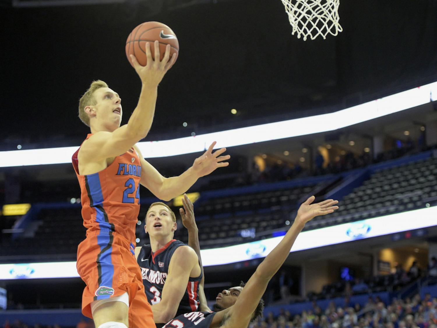 Florida guard Canyon Barry (24) drives to the basket over Belmont forward Amanze Egekeze (32) and guard Dylan Windler (3) in the first half of an NCAA college basketball game in Tampa, Fla., on Monday, Nov/ 21, 2016. (Andres Leiva/Tampa Bay Times via AP)