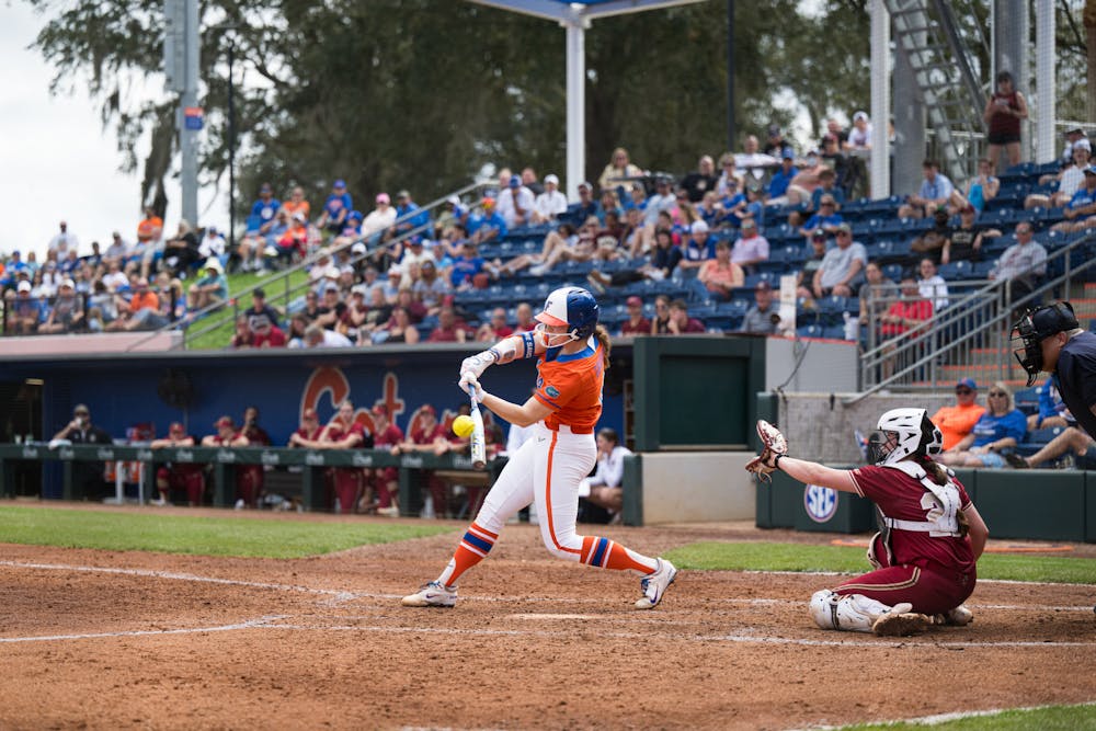 Florida Gators catcher Jocelyn Erickson (8) hits the ball in a softball game against Boston College in Gainesville, Fla., on Saturday, Feb. 15, 2025.