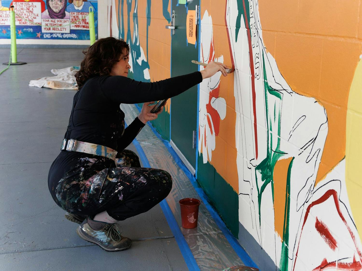 Jenna Horner, program director of Mindful Messages, paints a mural at East Side High School in Gainesville, Fla., Wednesday, March 11, 2026.