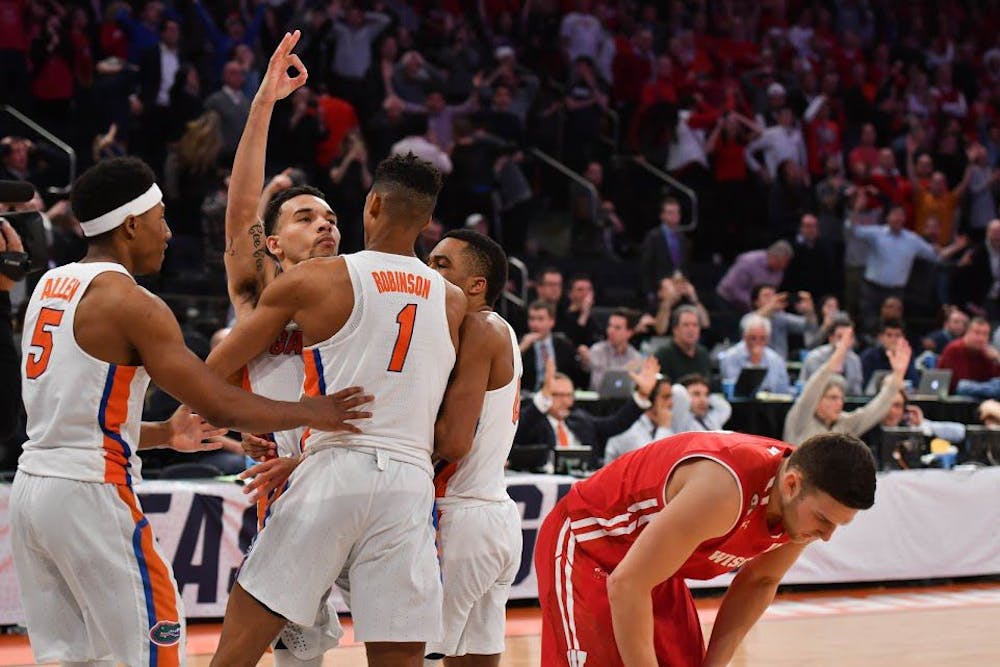<p>UF guard Chris Chiozza celebrates with teammates after hitting a buzzer-beater three to defeat Wisconsin 84-83 in the NCAA Tournament on Friday at Madison Square Garden in New York City.</p>