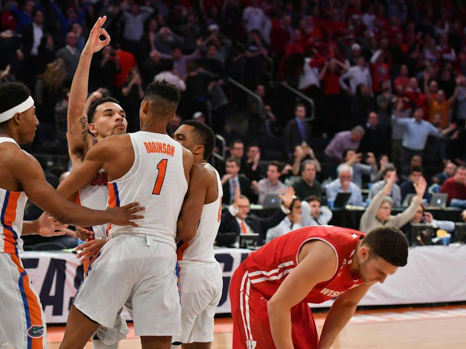 UF guard Chris Chiozza celebrates with teammates after hitting a buzzer-beater three to defeat Wisconsin 84-83 in the NCAA Tournament on Friday at Madison Square Garden in New York City.
