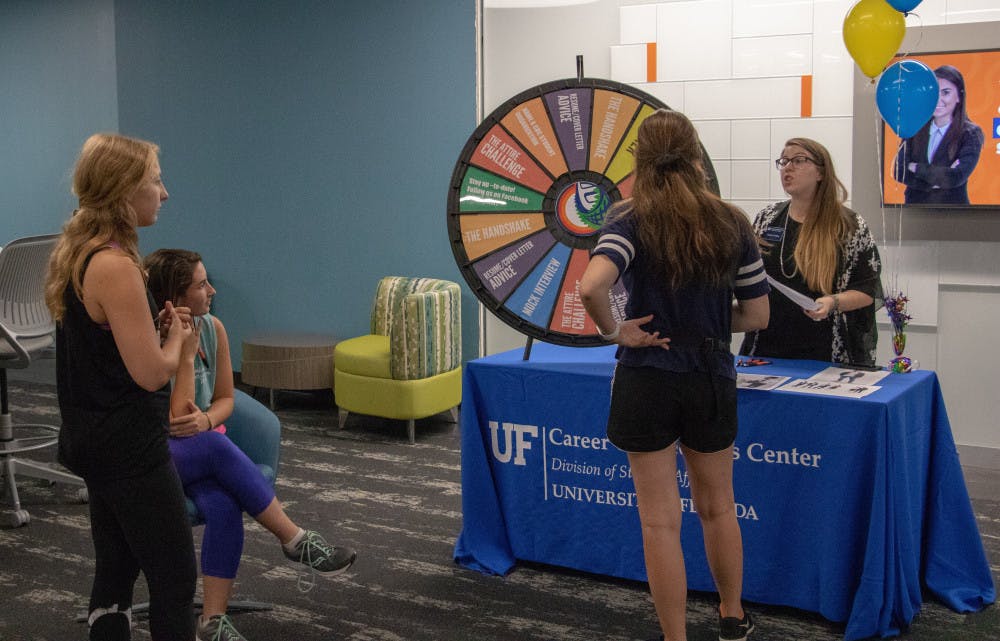 One of the staff members at the Career Connections Center speaks with students about the newly renovated space at the Connections Block Party on Thursday afternoon. 