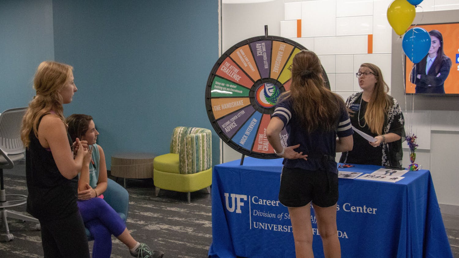 One of the staff members at the Career Connections Center speaks with students about the newly renovated space at the Connections Block Party on Thursday afternoon. 