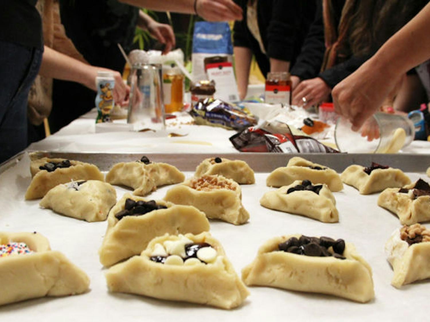 Team Koach prepares hamantaschen in a bake-off at UF Hillel on Wednesday. The cookies are filled with fruit, chocolate or other ingredients.
