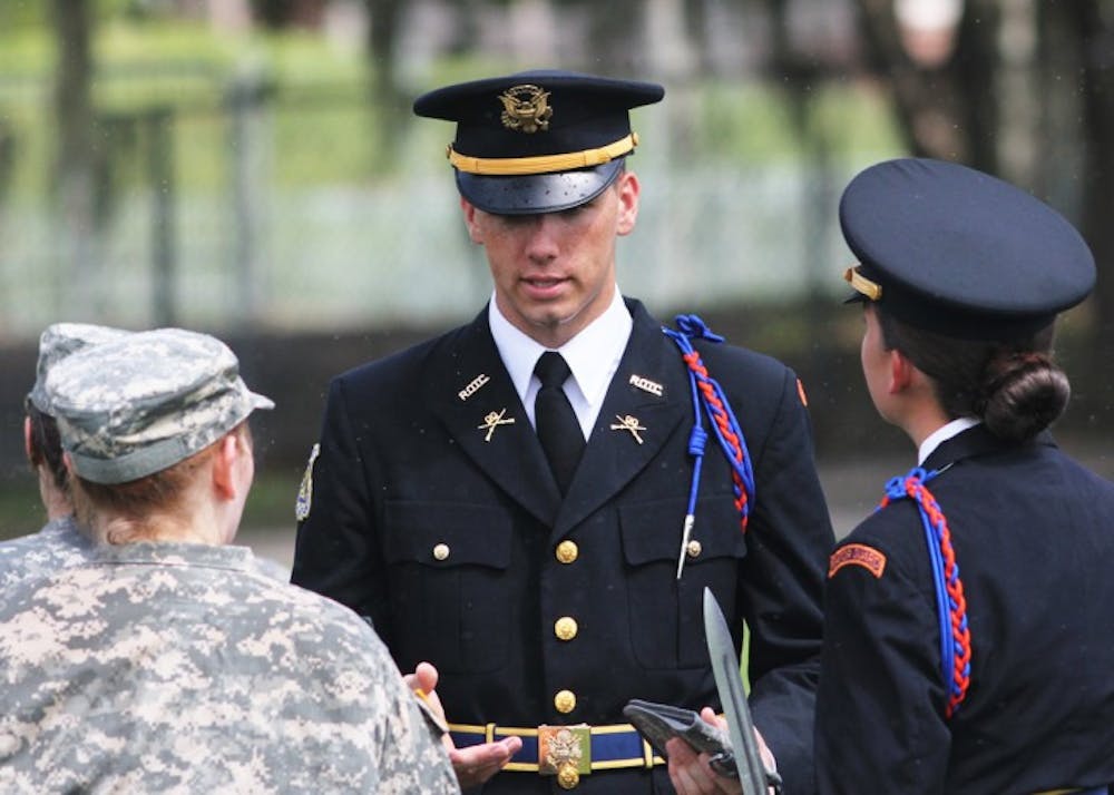 <p>Sean Lynch, an applied physiology and kinesiology sophomore, gives instruction during a UF Army ROTC event on Flavet Field on Thursday.</p>