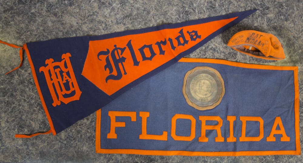 The University Archives at the George A. Smathers Libraries received a triangular pennant, a rectangular banner and a “rat cap” from the 1930s as a donation. They are among the oldest items in the university’s collection.&nbsp;