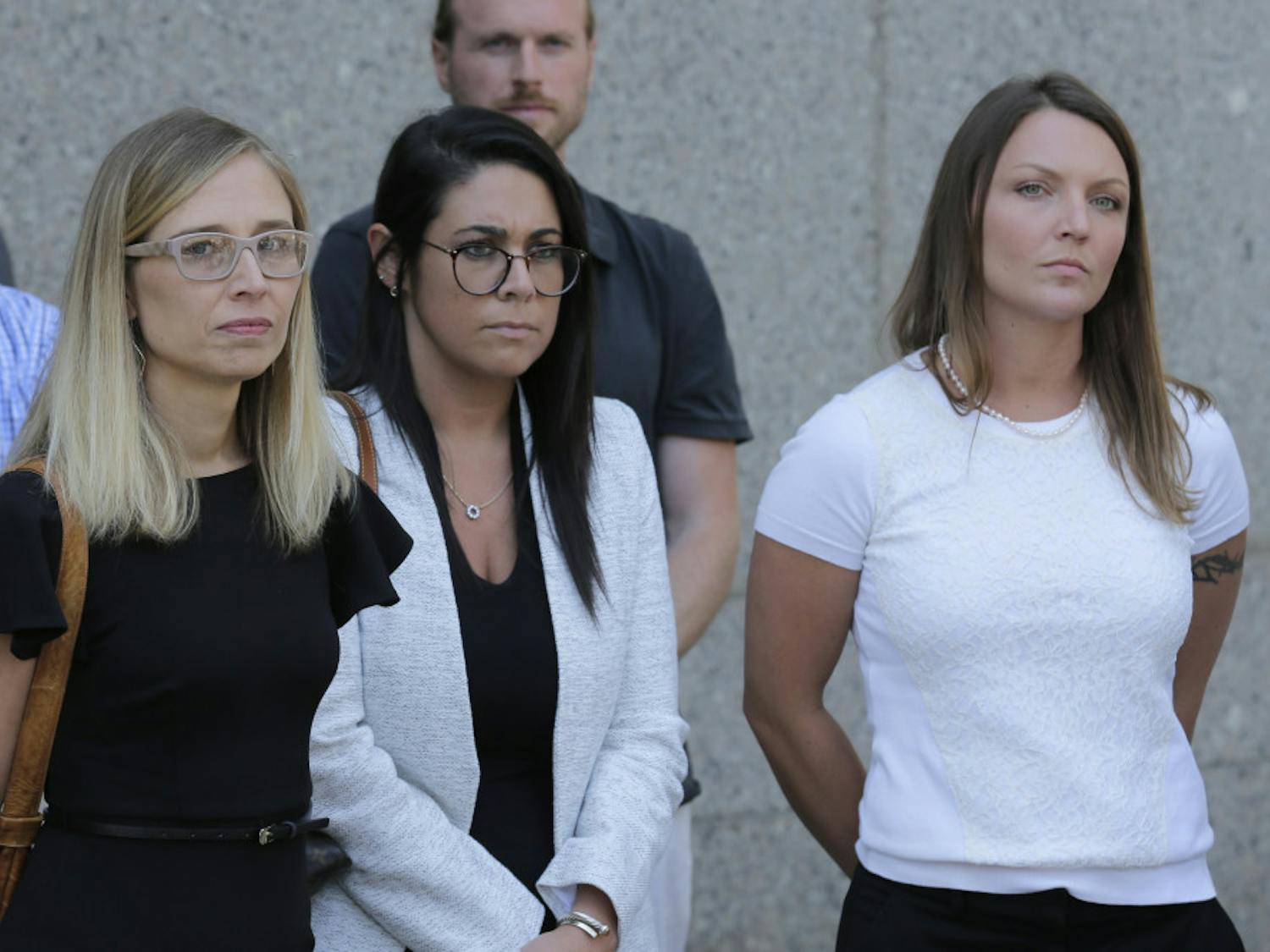 Annie Farmer, left, and Courtney Wild, right, accusers of Jeffery Epstein, stand outside the courthouse in New York, Monday, July 15, 2019. Financier Jeffrey Epstein will remain behind bars for now as a federal judge mulls whether to grant bail on charges he sexually abused underage girls.