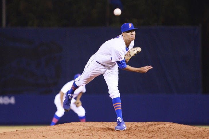Freshman Jay Carmichael warms up between innings during UF’s 8-2 loss to Florida Gulf Coast on Feb. 22. Carmichael walked four and hit two batters in Florida's 4-3 loss to Ole Miss on Friday.