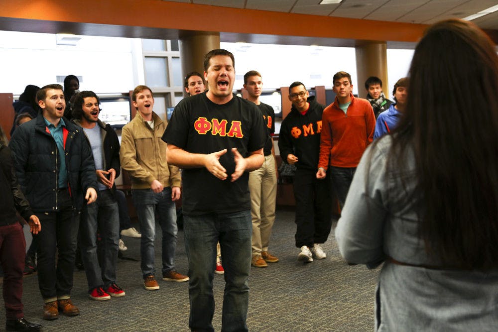 <p>Cole Lundquist, a 30-year-old UF music education graduate student, serenades a student with his fraternity Phi Mu Alpha on Wednesday at the Hub. The group will travel campus and Gainesville to give the serenades, which cost $30, donating about 75 percent of the proceeds to charity.</p>