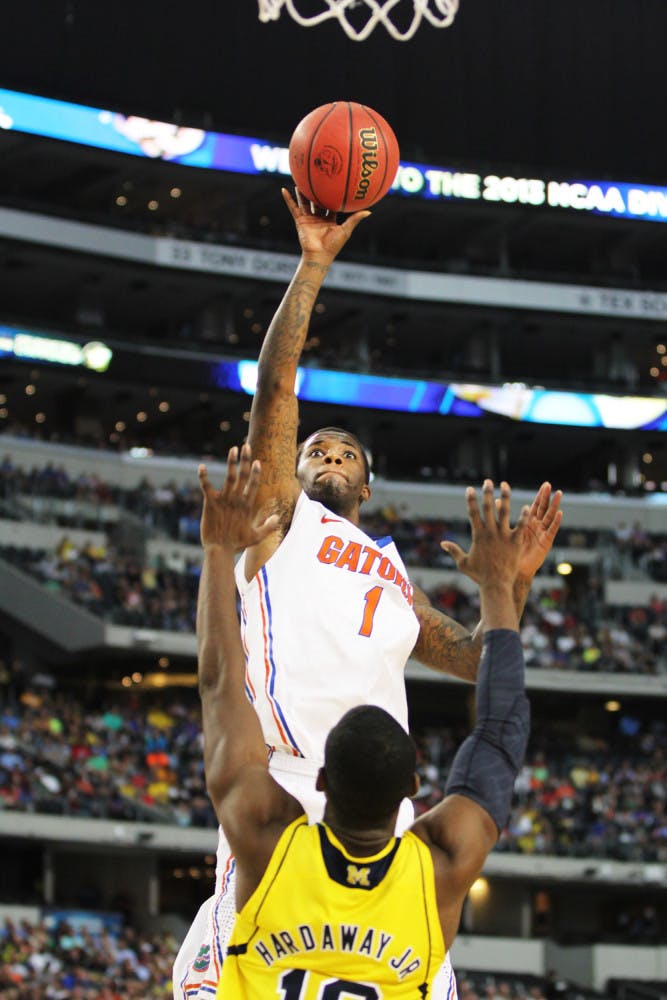 Senior guard Kenny Boynton attempts a shot against Michigan guard Tim Hardaway Jr. during Florida’s 79-59 loss on Sunday in Cowboys Stadium. Boynton missed the cut for the Los Angeles Lakers' summer league roster, which was released Thursday. 