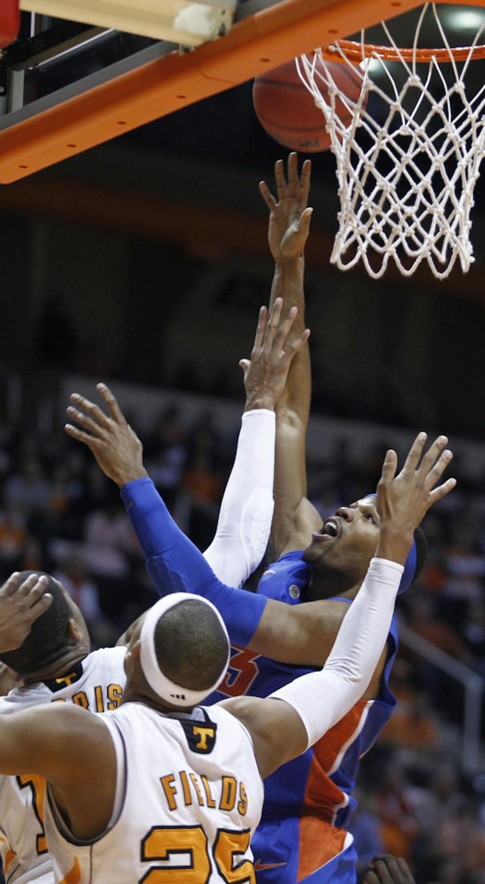 UF forward Alex Tyus shoots over Tennessee defenders during the Gators’ 81-75 overtime win in Knoxville, Tenn., on Tuesday night.