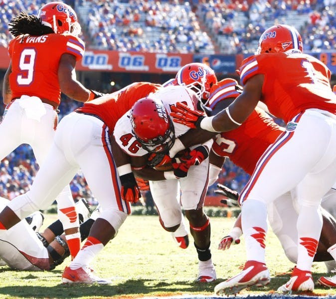 Louisiana running back Alonzo Harris (46) bursts through a pack of defenders to score in UF’s 27-20 win. Unlike most non-BCS teams, the Ragin’ Cajuns tested the Gators.&nbsp;