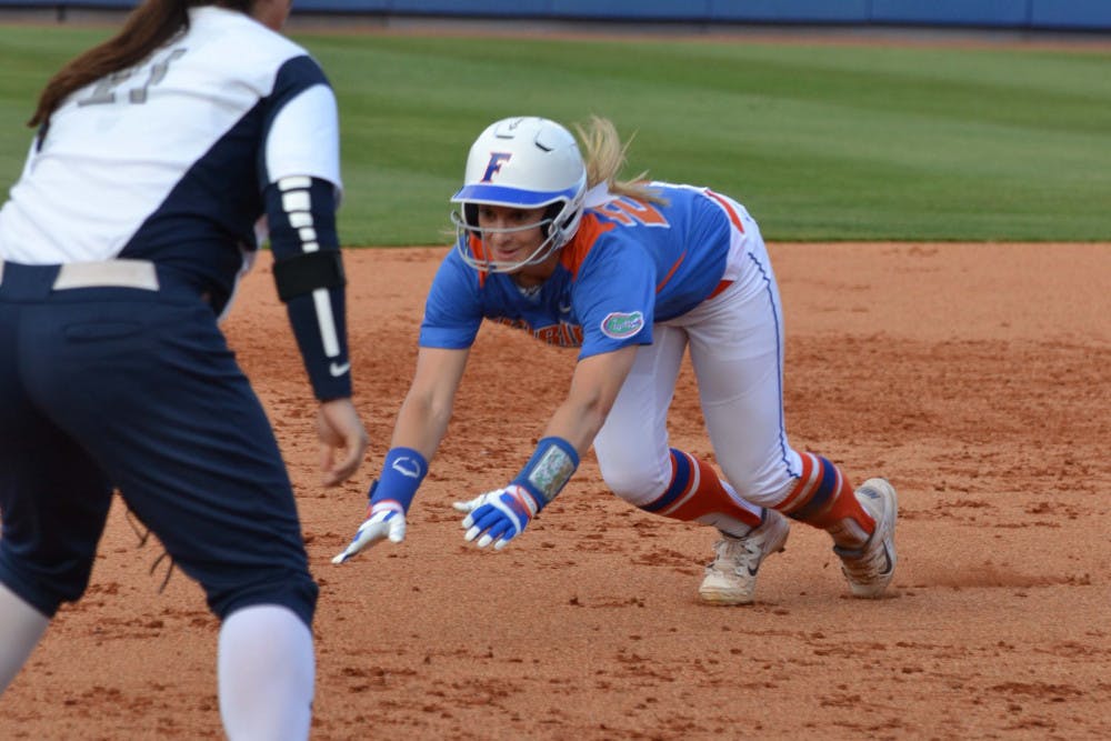 Kirsti Merritt smiles as she slides into third base during Florida's 2-1 win against North Florida on April 1, 2015, at Katie Seashole Pressly Stadium.