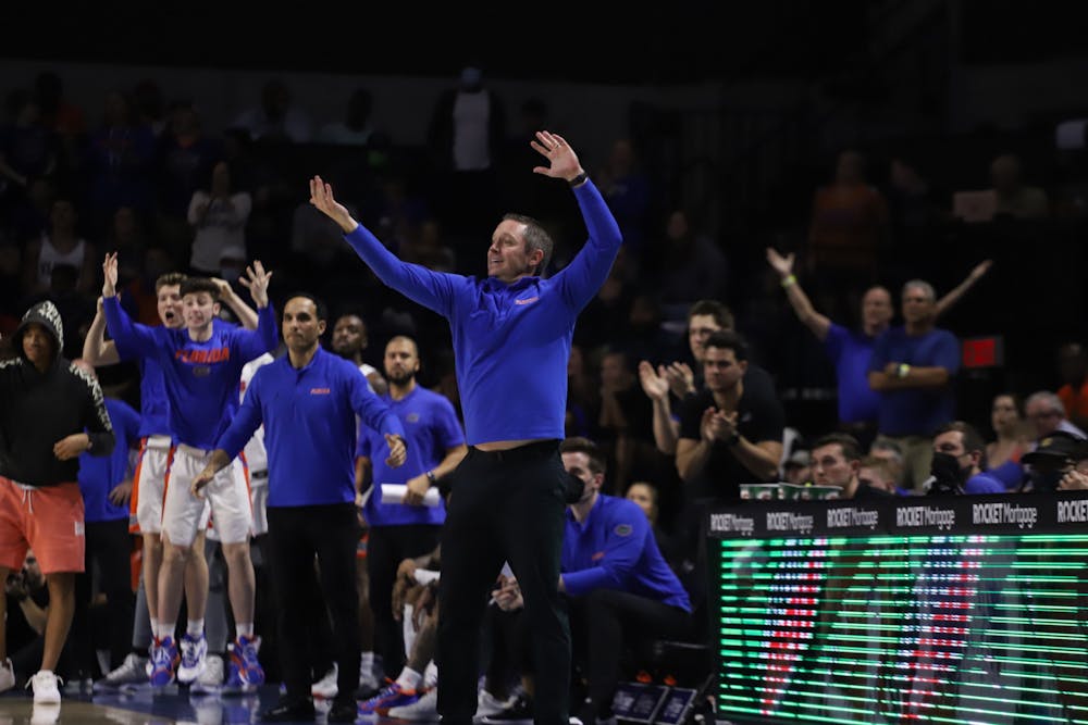 <p>Gators head coach Mike White sends signals to his team during a Feb. 22 matchup with Arkansas. Florida lost in the second round of the SEC tournament </p>