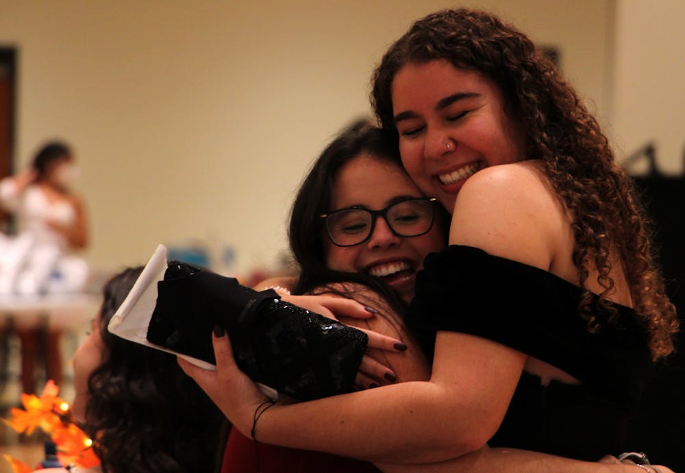 Daniella Duarte (left), 21, UF finance sophomore, receives a hug from her friend Gabriella Barreras (right), 20, UF advertising junior, during the masquerade ball in the Rion Ballroom at the Reitz Union on Thursday, Sept. 16, 2021. 