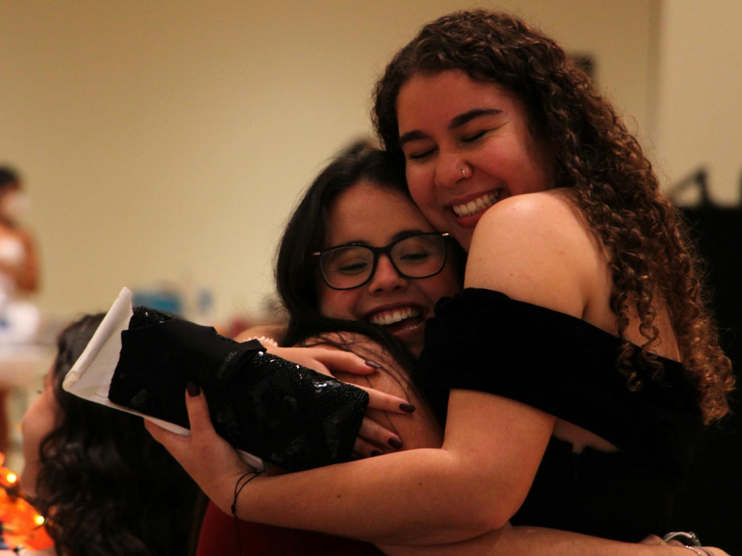 Daniella Duarte (left), 21, UF finance sophomore, receives a hug from her friend Gabriella Barreras (right), 20, UF advertising junior, during the masquerade ball in the Rion Ballroom at the Reitz Union on Thursday, Sept. 16, 2021.