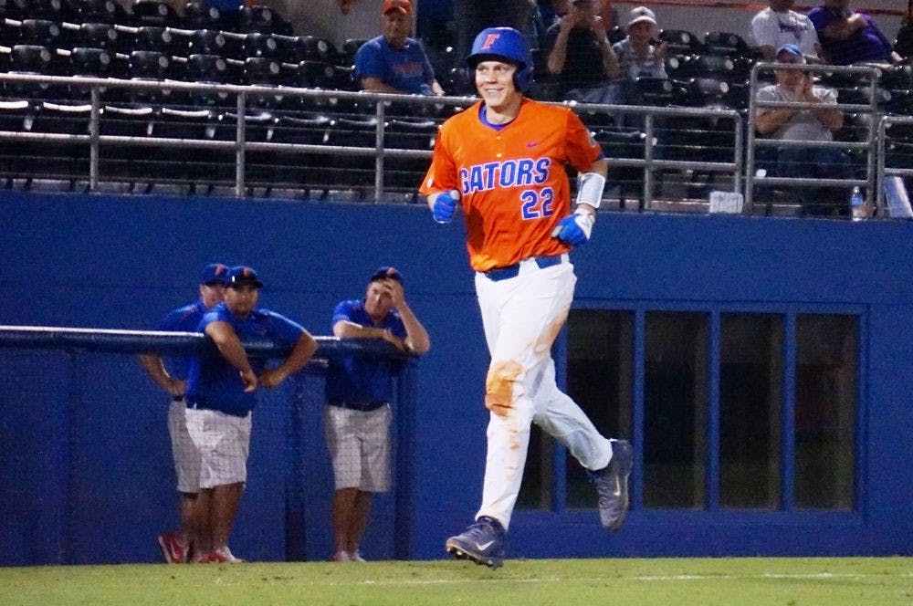 <p>JJ Schwarz smiles as he runs toward home plate after hitting a two-run home run during Florida's 8-7 win against Fairfield on Tuesday at McKethan Stadium.</p>