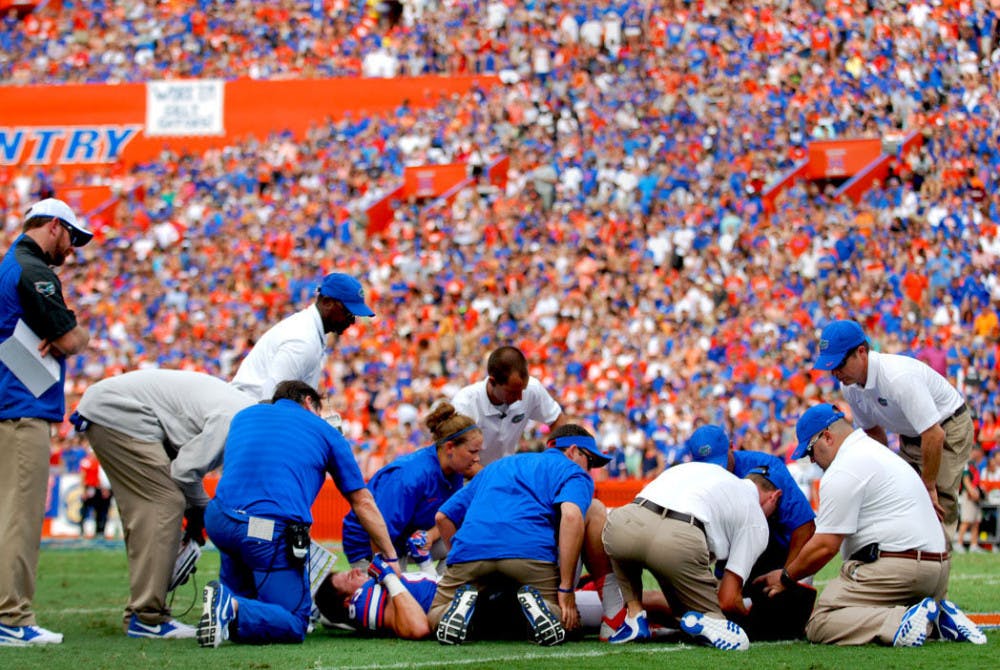 <p>Redshirt senior tight end Jake McGee lies on the field injured during Florida's 65-0 victory against Eastern Michigan on Saturday at Ben Hill Griffin Stadium. McGee broke his tibia and fibula and will be out for the season, Muschamp said.</p>
