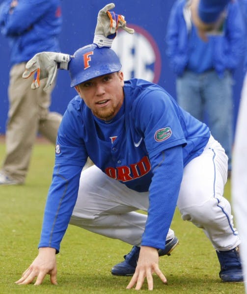 Shortshop Nolan Fontana makes the most of a rain delay Sunday by pretending to be a deer. Teammates in a center-field TV tower bagged the 10-point buck before the game was called in the sixth inning with the Gators leading 5-3. UF swept the three-game series.