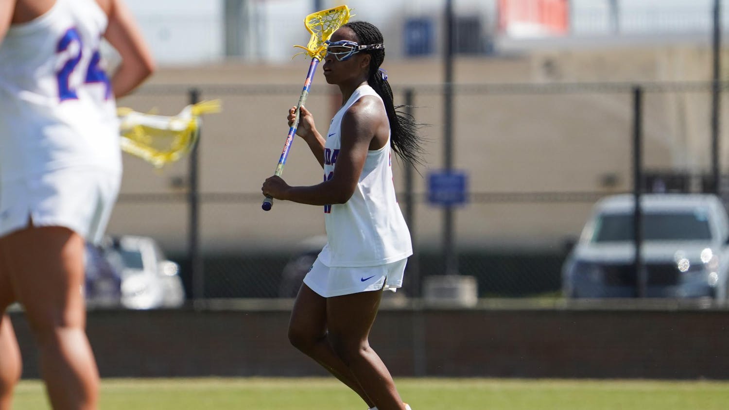 Clark Hamilton (21) looks to pass the ball in an NCAA women’s lacrosse game against Penn, Wednesday, March 11, 2026, in Gainesville, Fla.