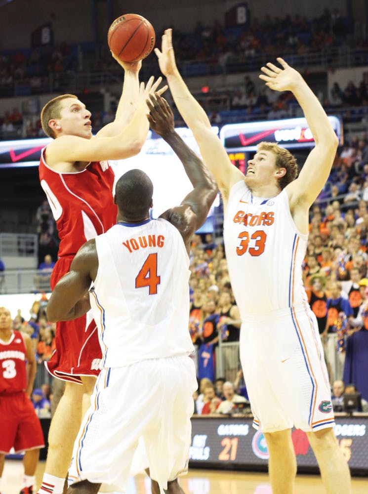 Erik Murphy (33) and Patric Young (4) try to block a shot from Jared Berggren during Florida's 74-56 win at home against Wisconsin on Nov. 14th. While the No. 13 Gators are 9-2, their defensive efficiency numbers have been down the last two games.
