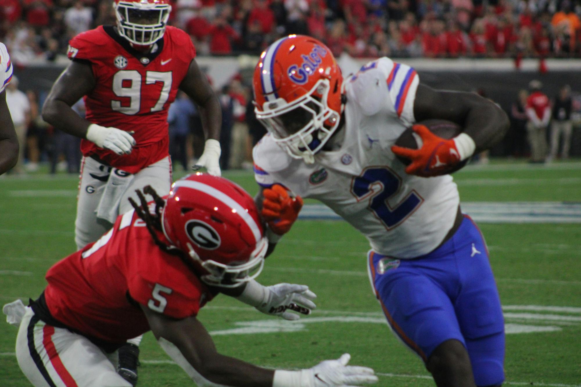 Running back Montrell Johnson Jr. runs the ball against a Georgia defender in the Gators' 42-20 loss to the Georgia Bulldogs on Saturday, Oct. 29, 2023.