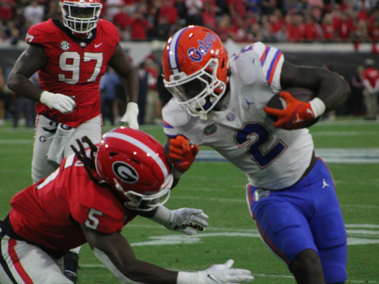 Running back Montrell Johnson Jr. runs the ball against a Georgia defender in the Gators' 42-20 loss to the Georgia Bulldogs on Saturday, Oct. 29, 2023.