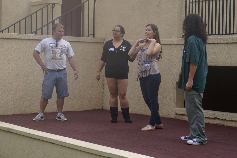 <p>Guild members (from left) Scott West, Kayte Sands, Mollie Lassiter and Miranda Lipsig perform a skit during Thieves Guild auditions at the Thomas Center Galleries on Aug. 29, 2015.</p>